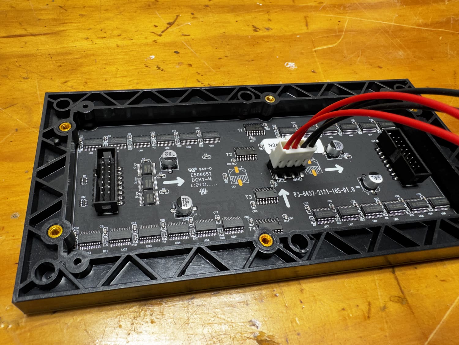 Back of a P3 64 by 32 LED panel showing the HUB75 input and the power plug aligned with VCC and GND